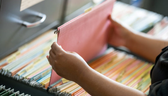 business woman hands searching information in Stack of papers files on work in office, business woman hands searching information in Stack of papers files on work in office,