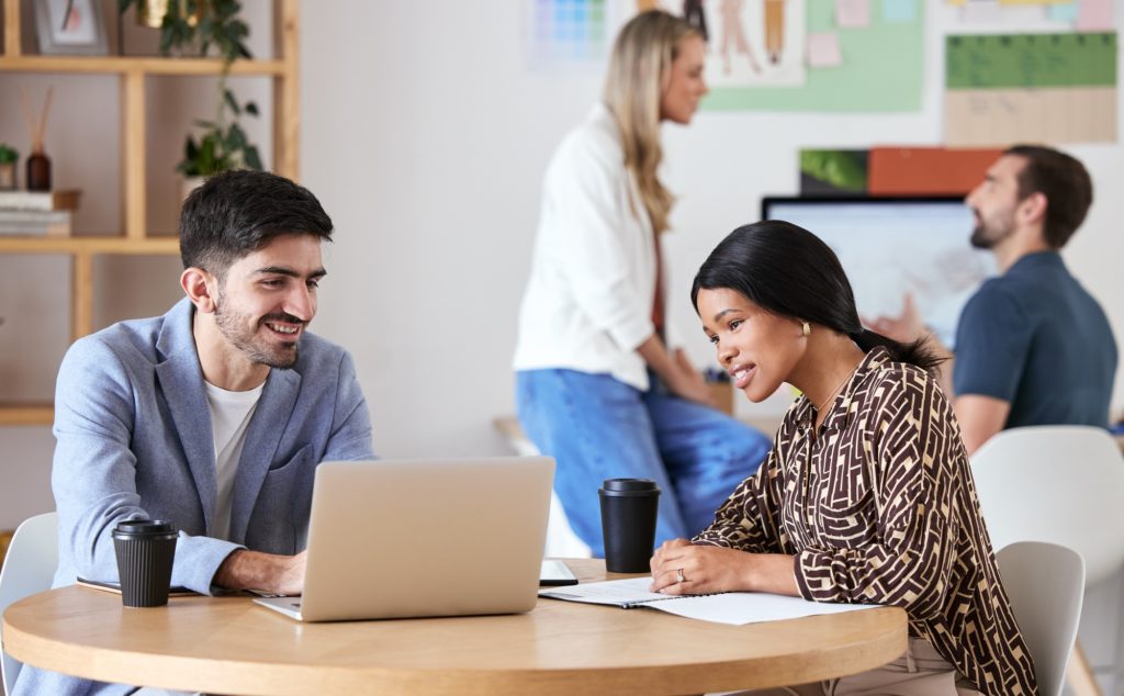 Collaboration, teamwork and strategy meeting for business colleagues sitting at a desk and working